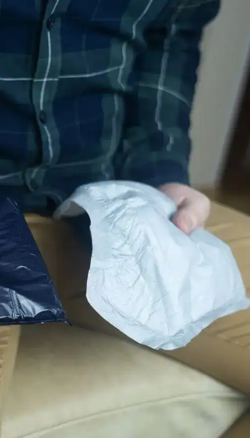 Image of man holding incontinence pads as part of overactive bladder treatment Northampton