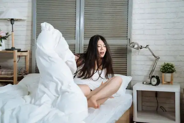 Image of woman getting up because of nighttime leaks Northampton